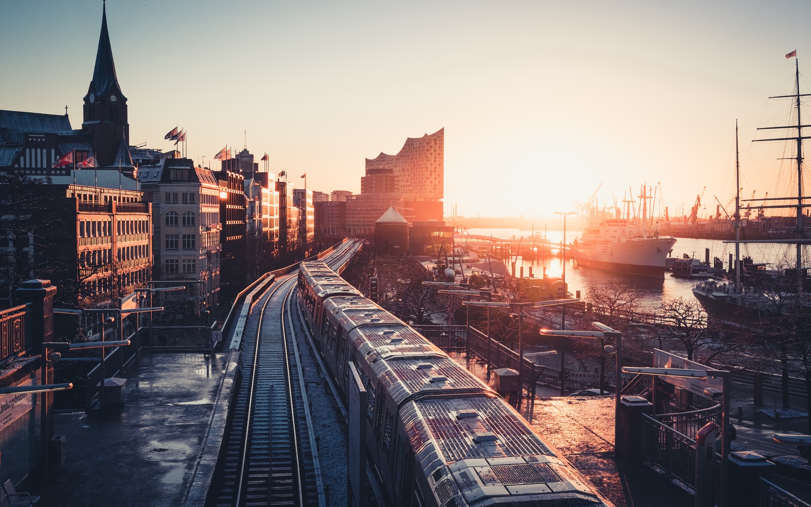 city buildings near the road during sunset