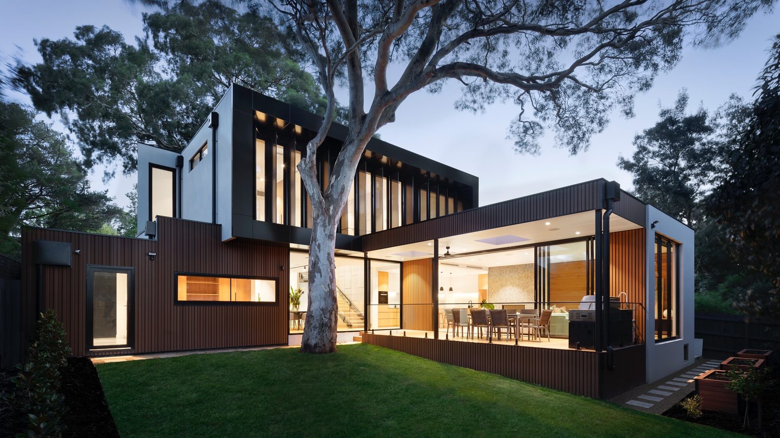 brown and white wooden house near green trees during daytime